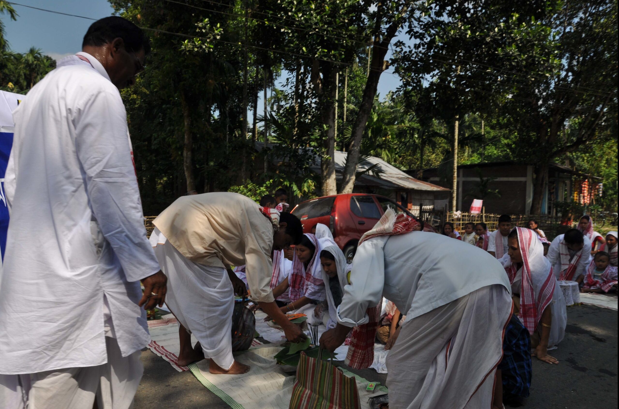 A group of people performing Dashami pooja on the road