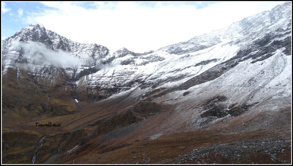 Snowy mountains and a brown valley