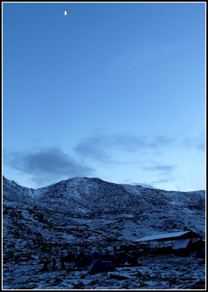 Snowy mountains against a moonlit night