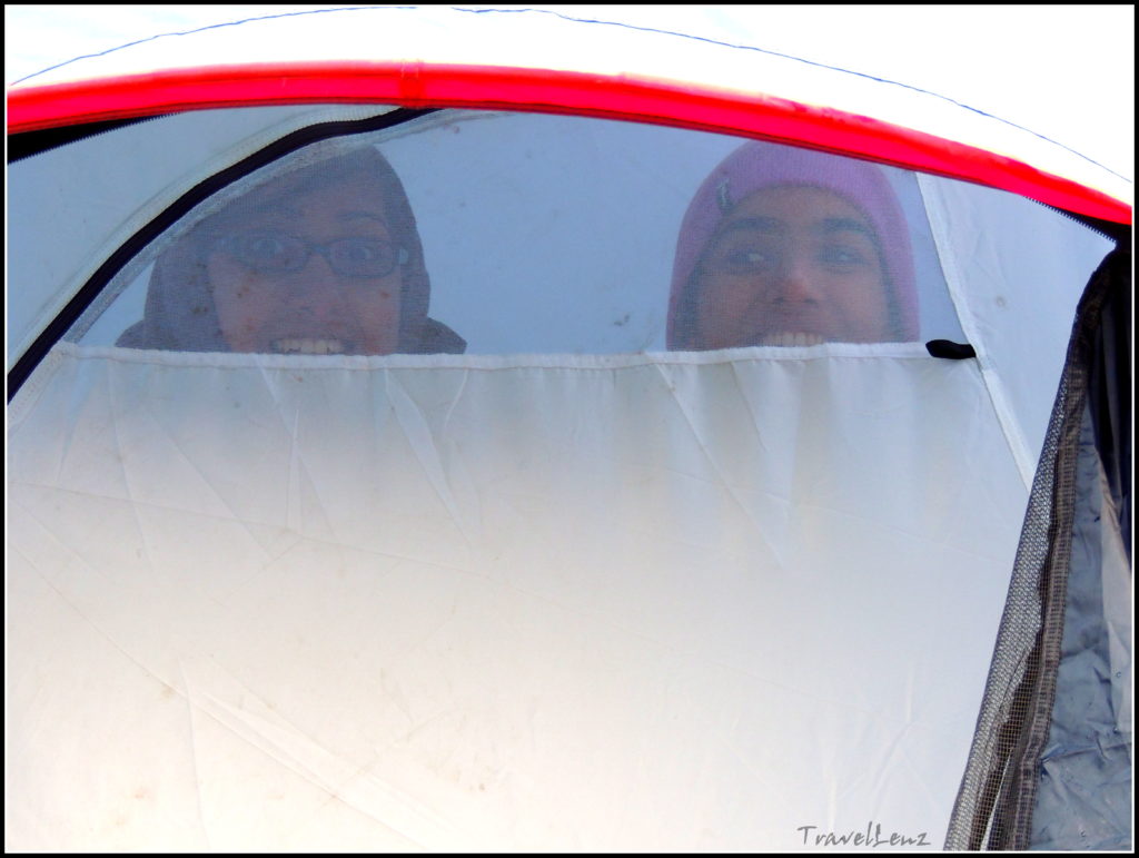 Trekkers peep out of a tent