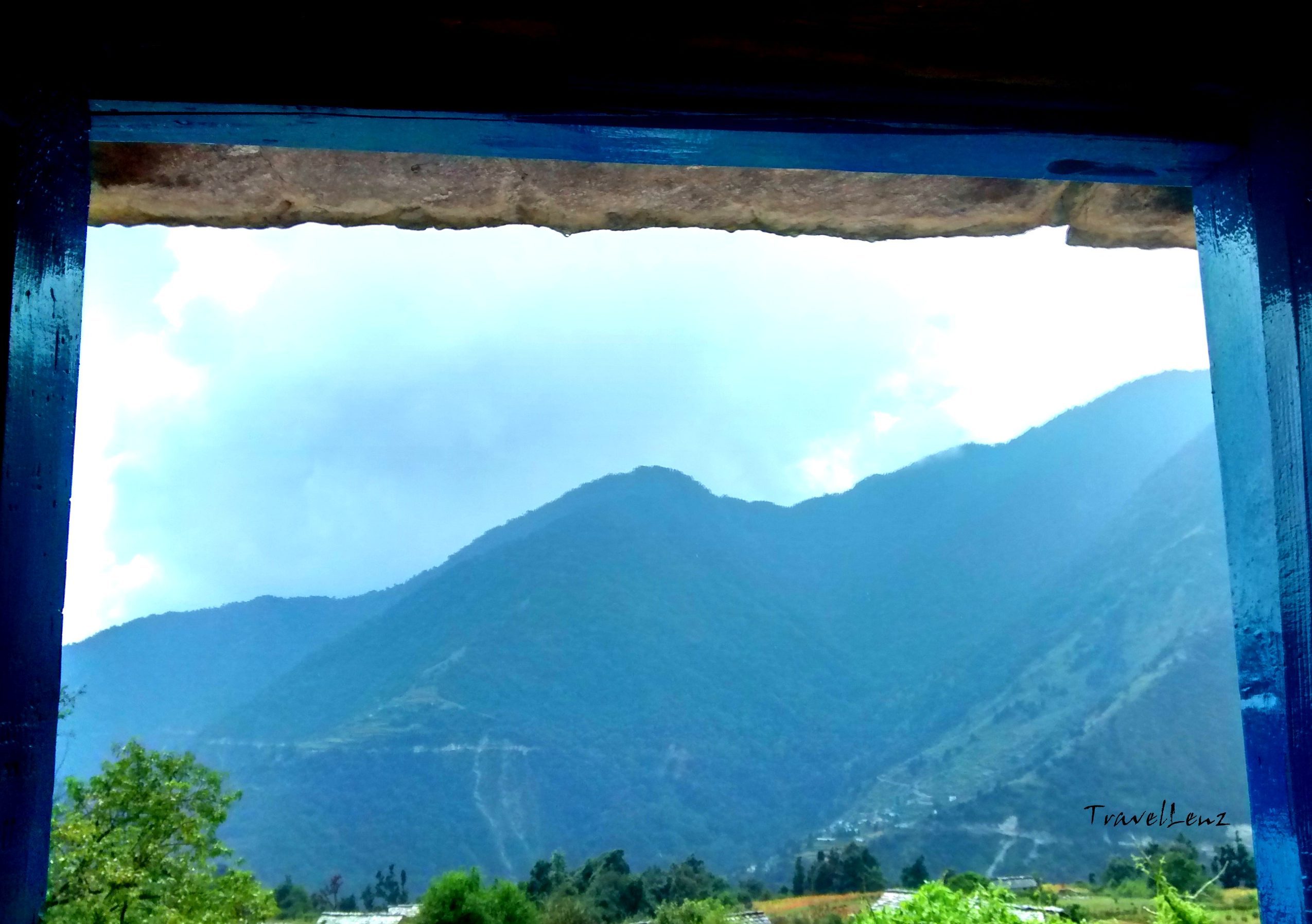 View of the green mountains through a window
