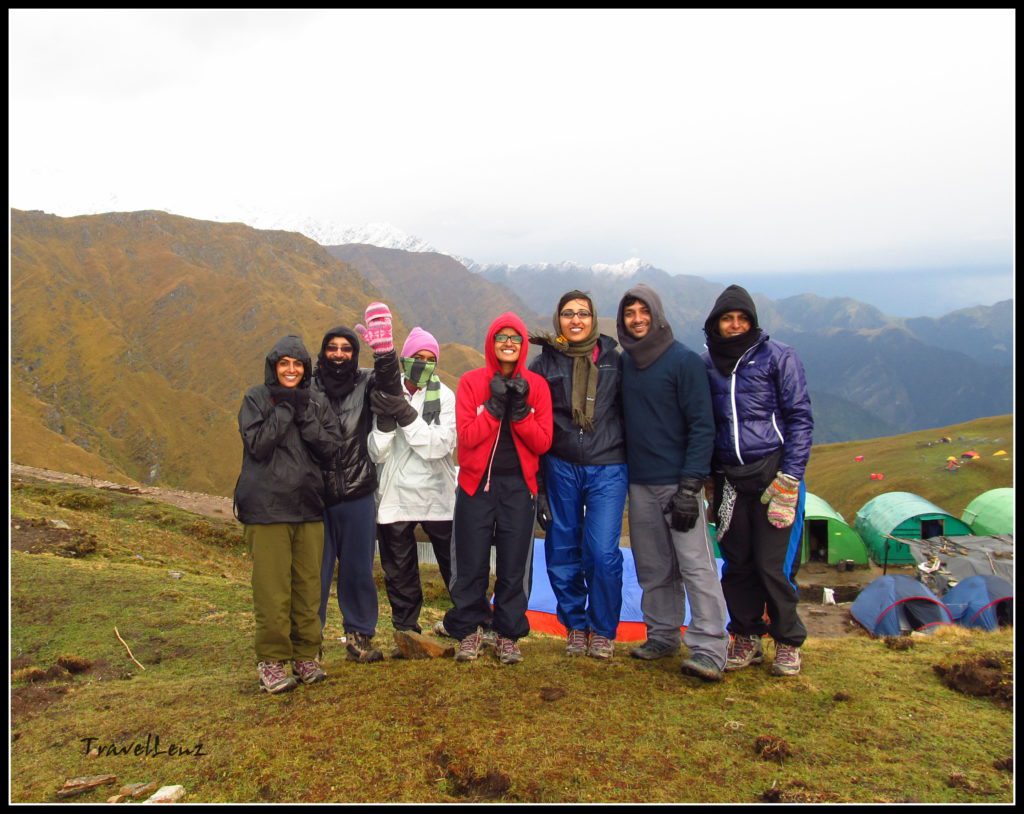 Trekkers posing in front of a campsite