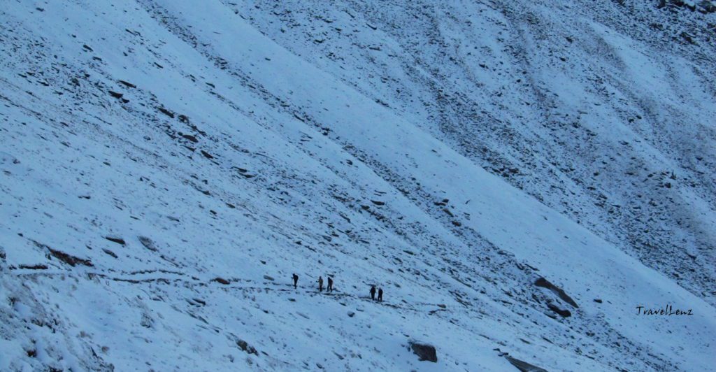 A group of trekkers walk in the snow
