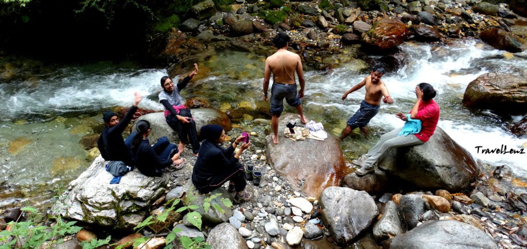 Trekkers sitting by a brook