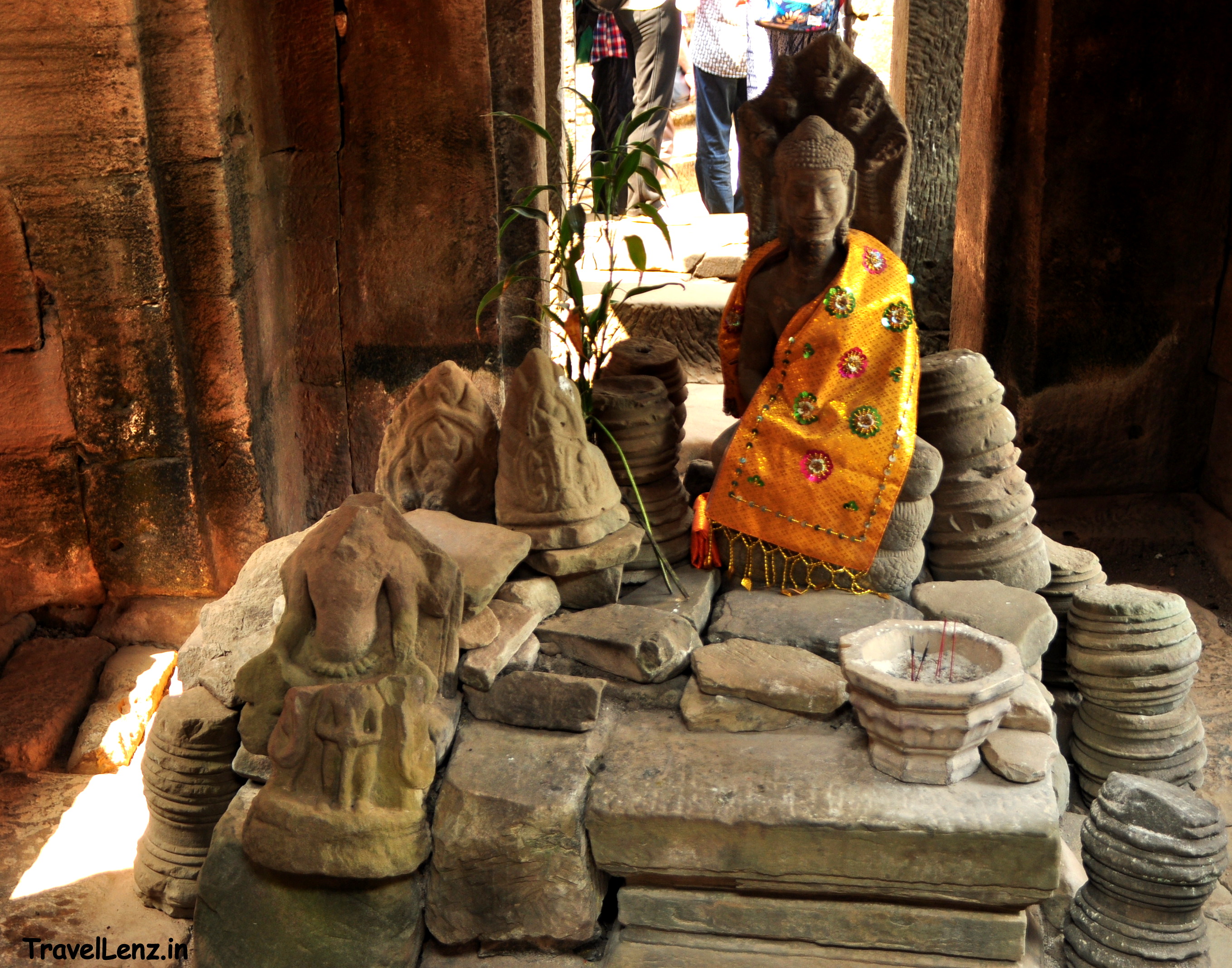 A seated Buddha image sheltered under the hoods of a snake