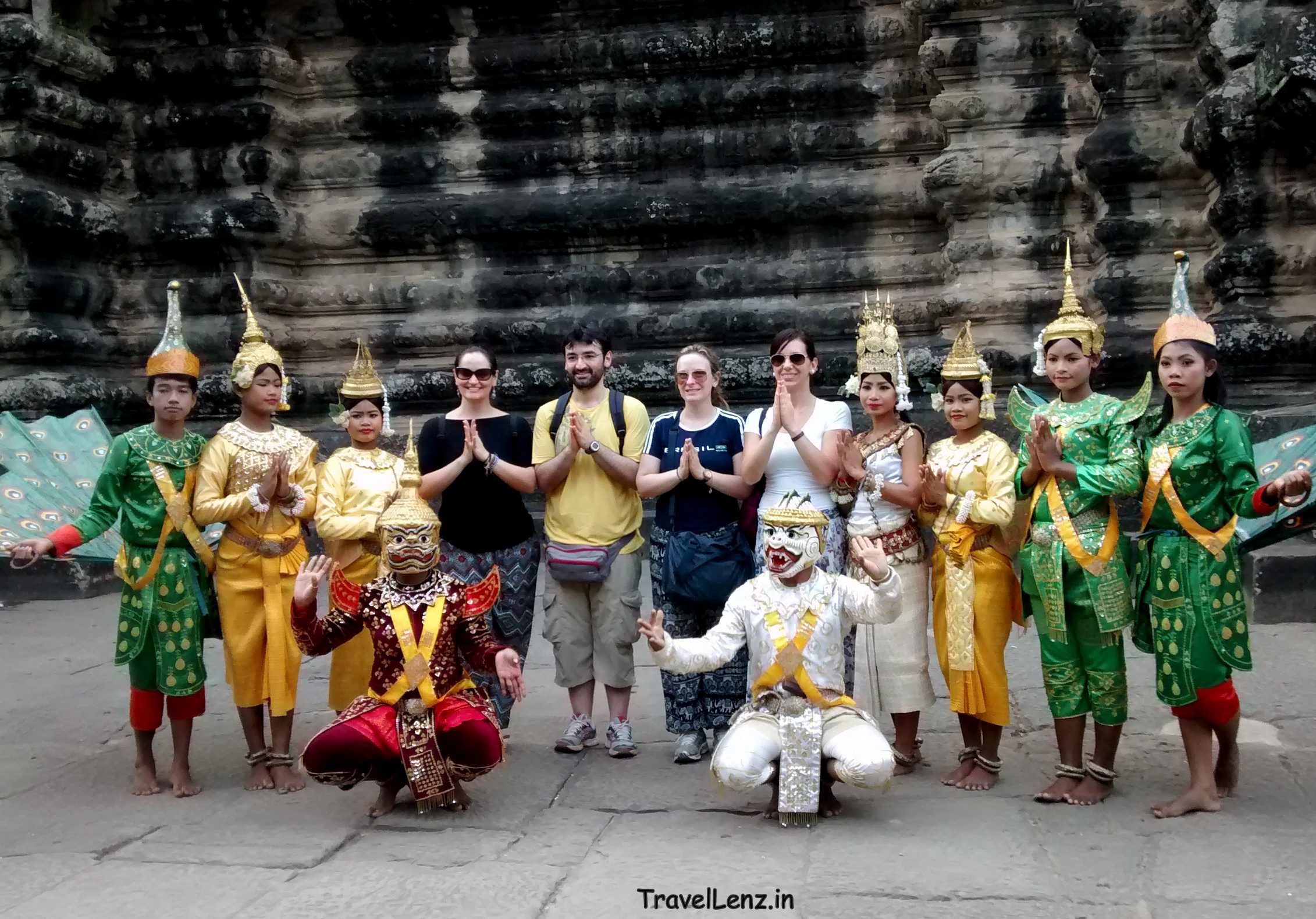 Apsara dancers in traditional Khmer attire posing for tourists in Angkor Wat