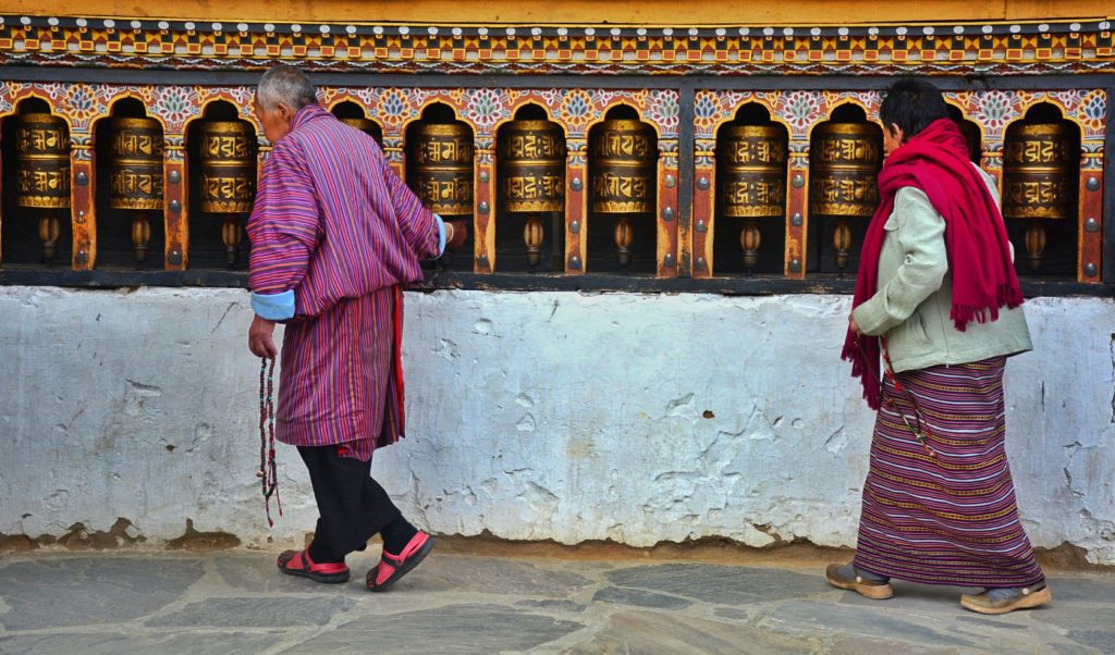 A couple at the prayer wheels at the Changangkha lhakhang monastery in Thimphu