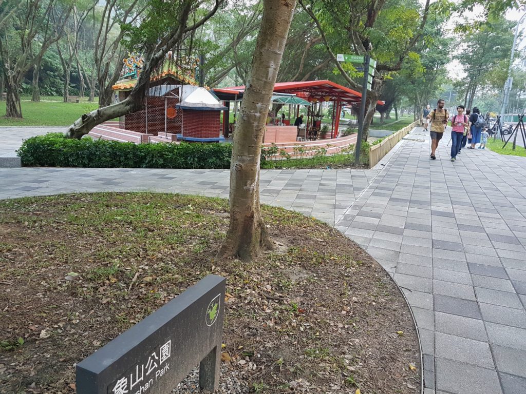 People walking past a park