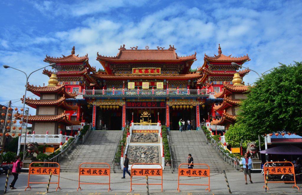A large temple with stairs, amidst a blue sky