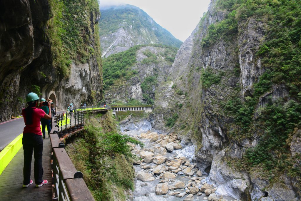 Visitors looking out at the deep Taroko gorge surrounded by tall mountains