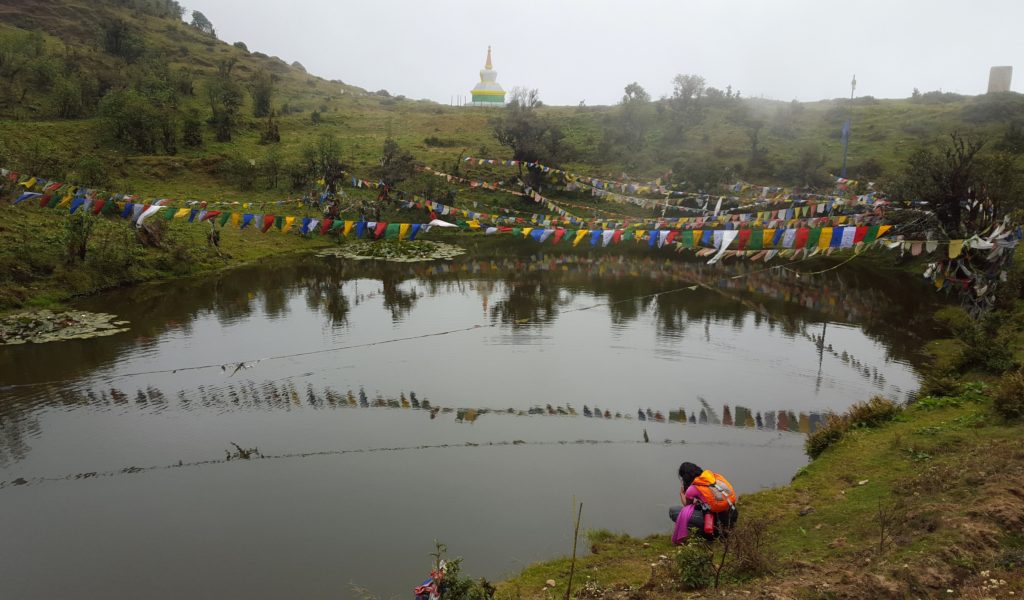 An alpine lake with prayer flags fluttering