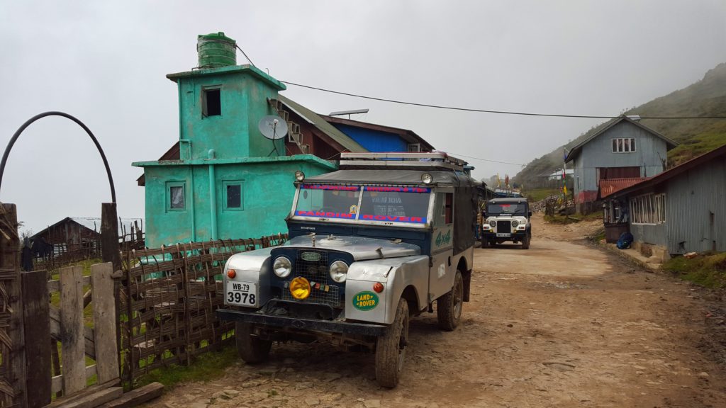 Land Rovers parked outside a teahouse