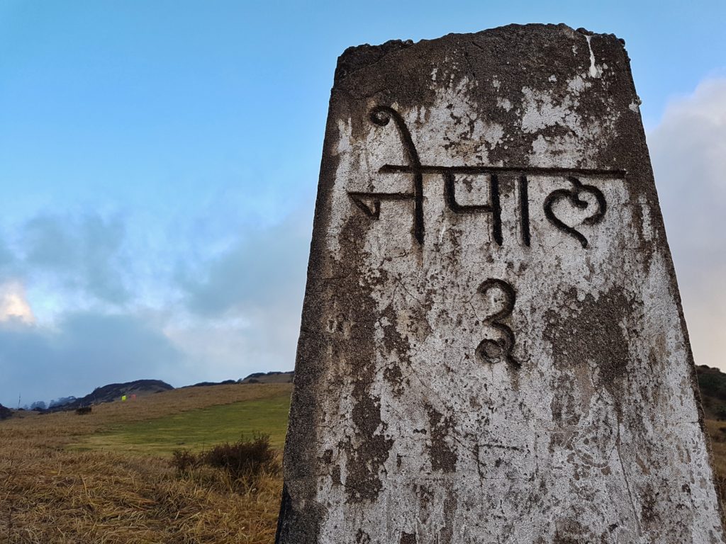 A mile stone with nepal written